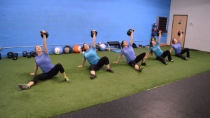 'Achieve Fitness Women Doing 24kg TGUs'